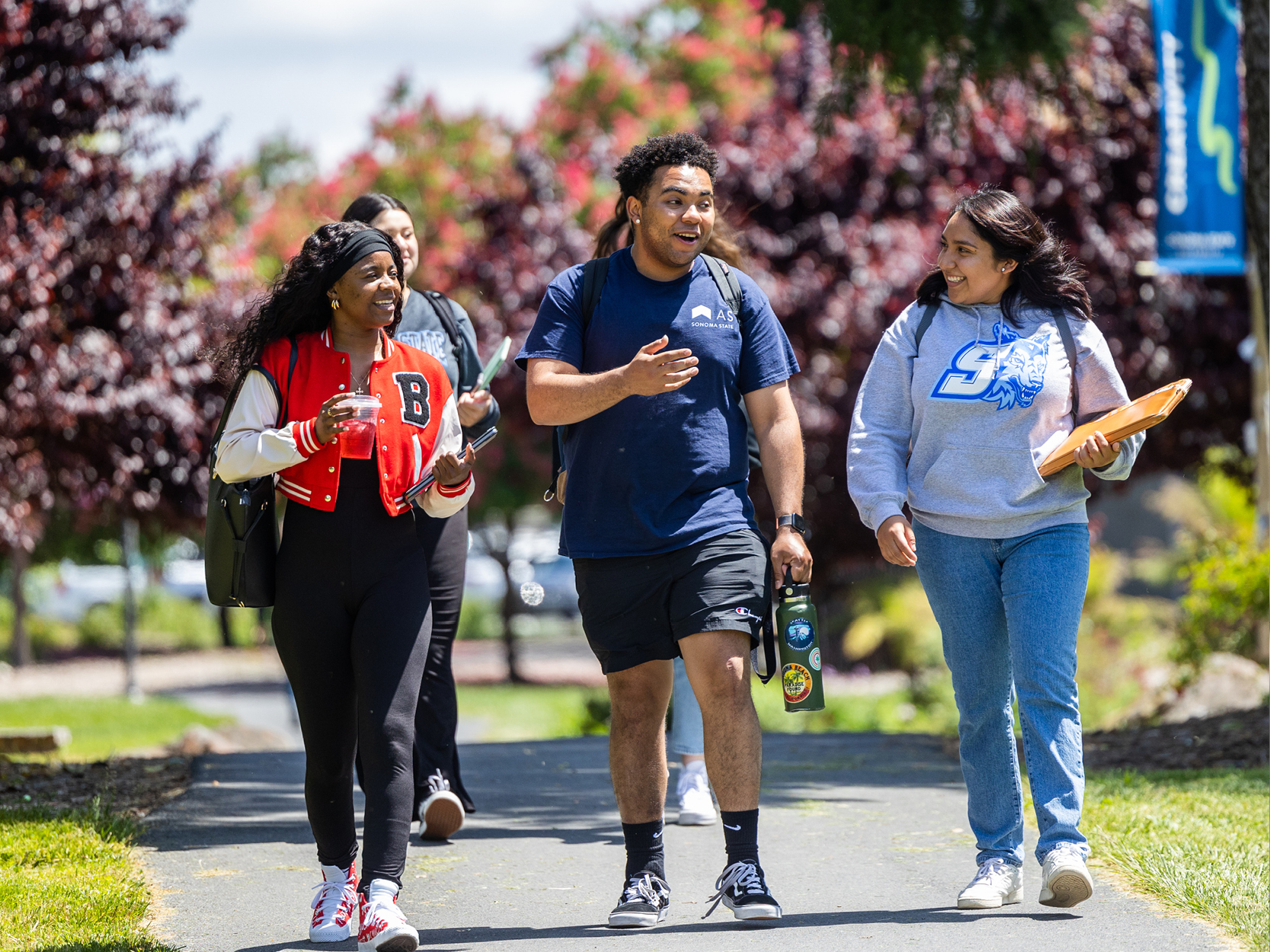 Group of students walking on campus and talking