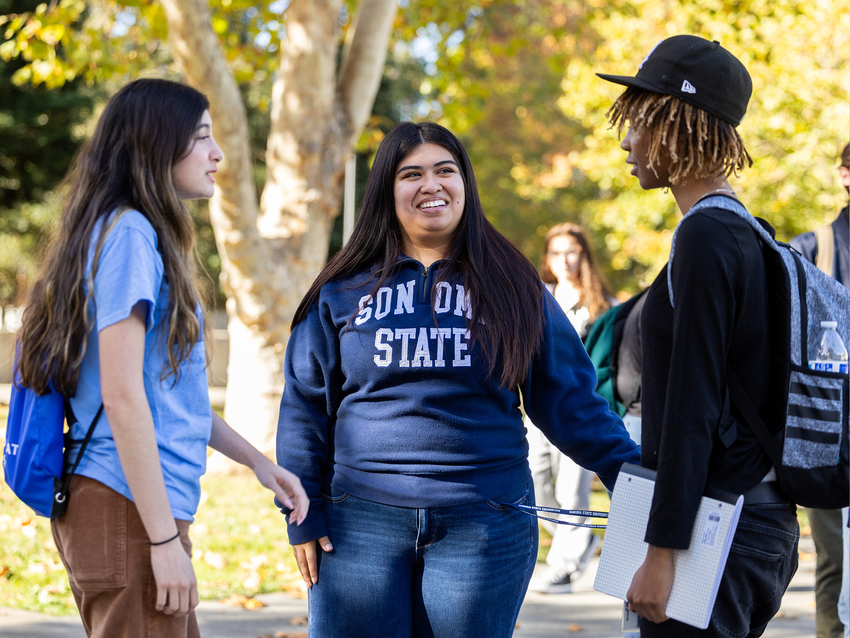 Students standing and talking to a group