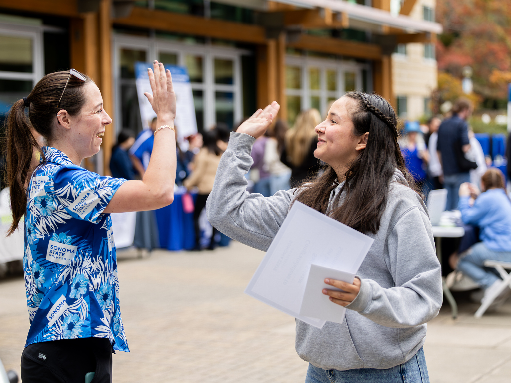 Two people high fiving