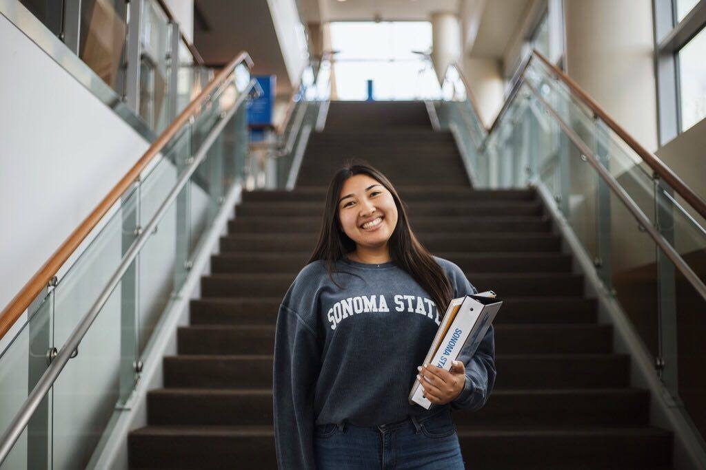 SSU student standing in stairway smiling