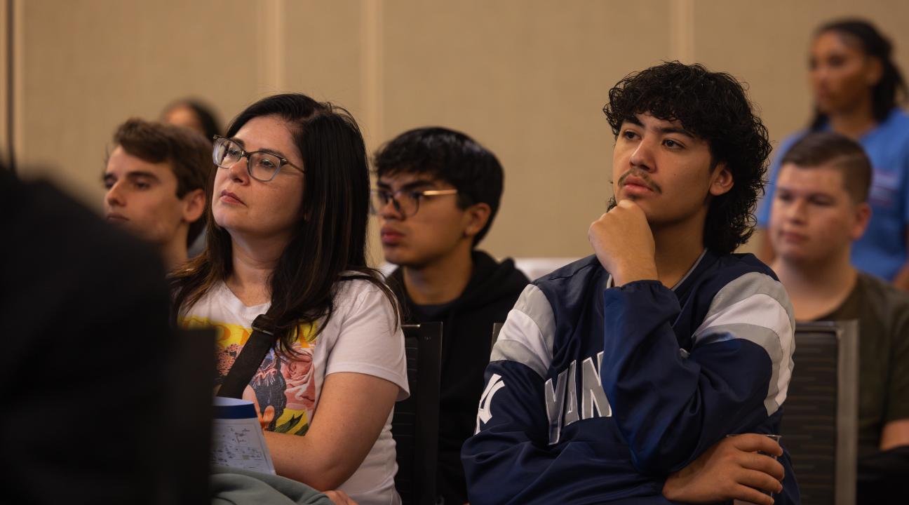 Student and parent sitting listening to a presentation