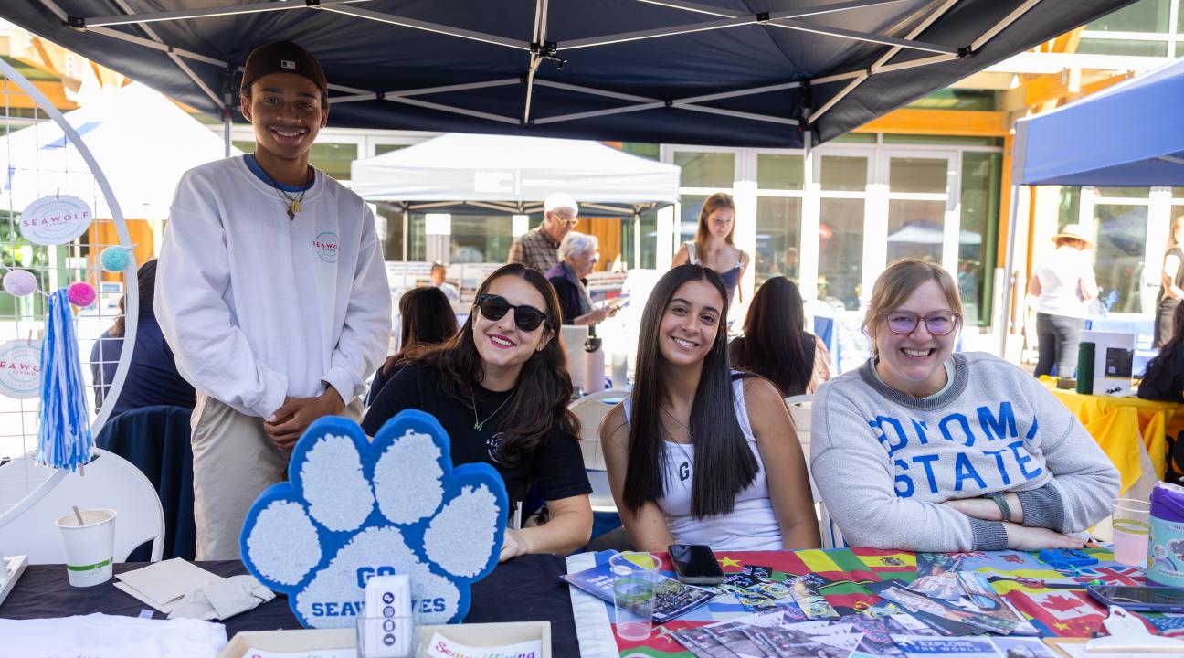 Group of people sitting at a table with brochures in front of them