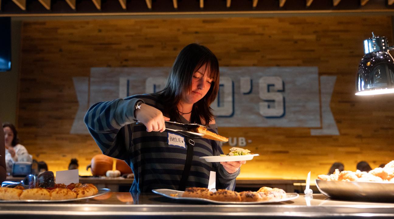 Person grabbing pizza