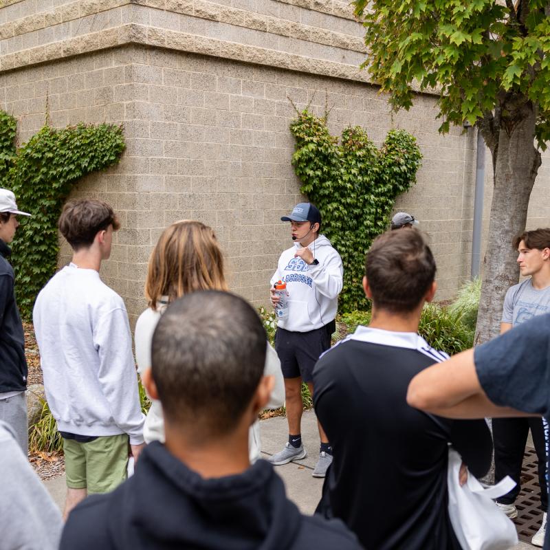 Tour guide leading a group of people and talking to them