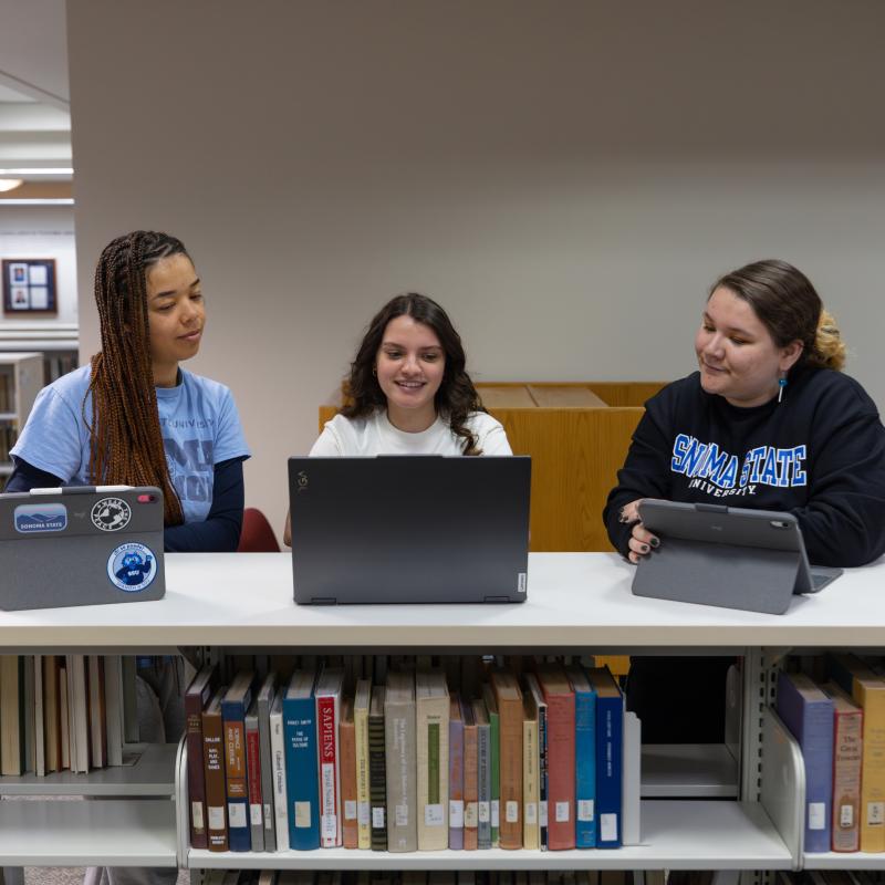 3 students looking at their transcripts