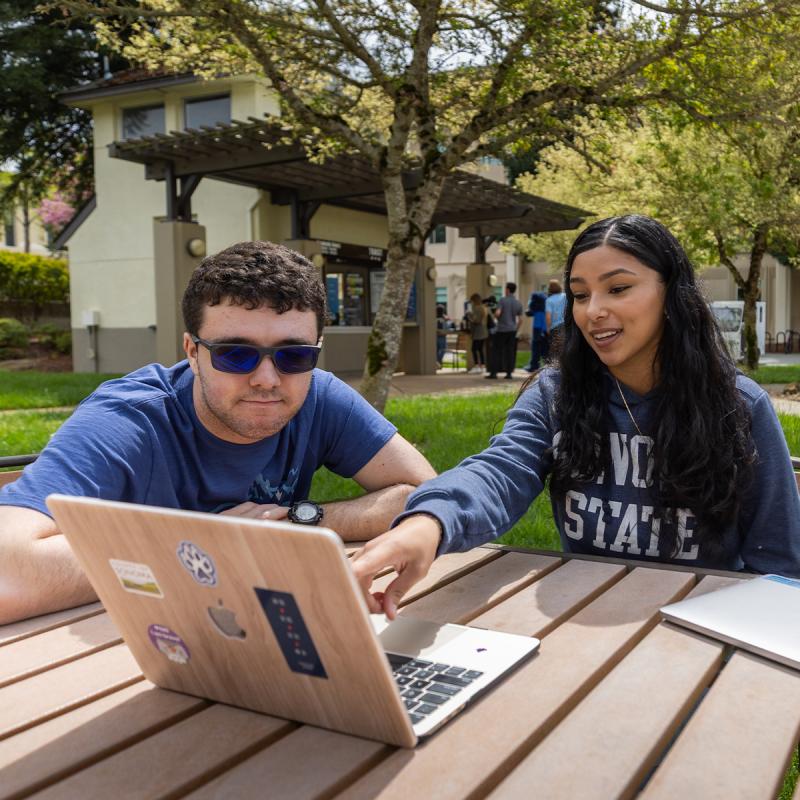 two students looking for online resources 