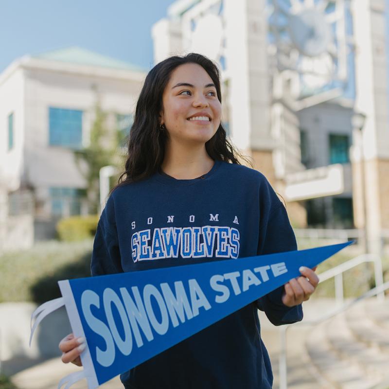 Freshman student holding an SSU flag