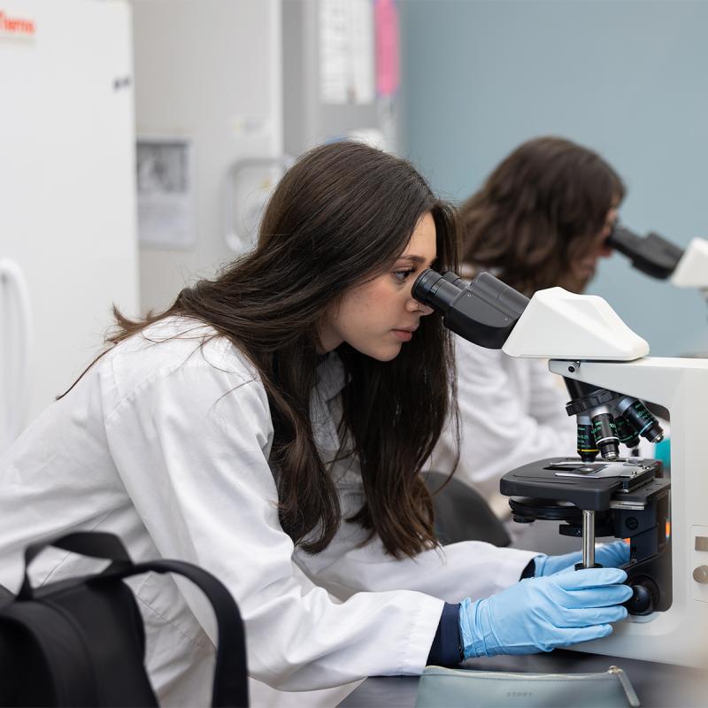 Student looking through a microscope
