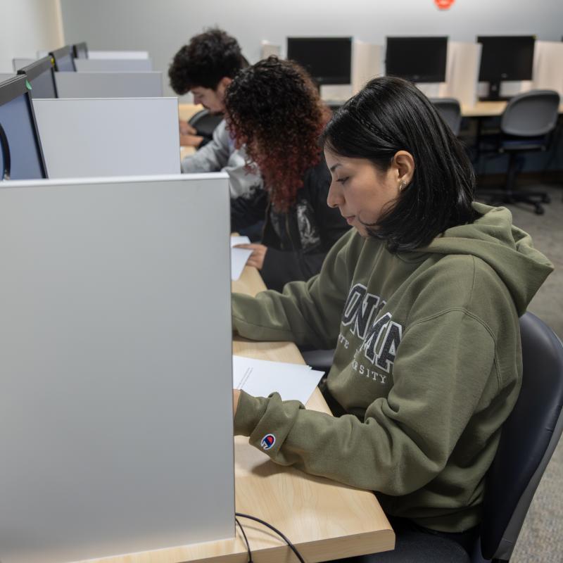 Group of three students in a quite office area taking a test 