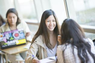 Female student smiling at friend