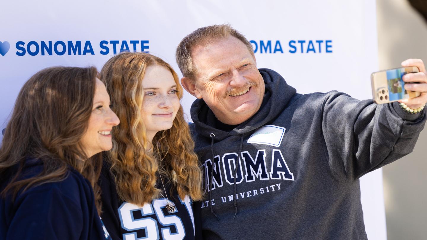 Two parents and a student taking a selfie