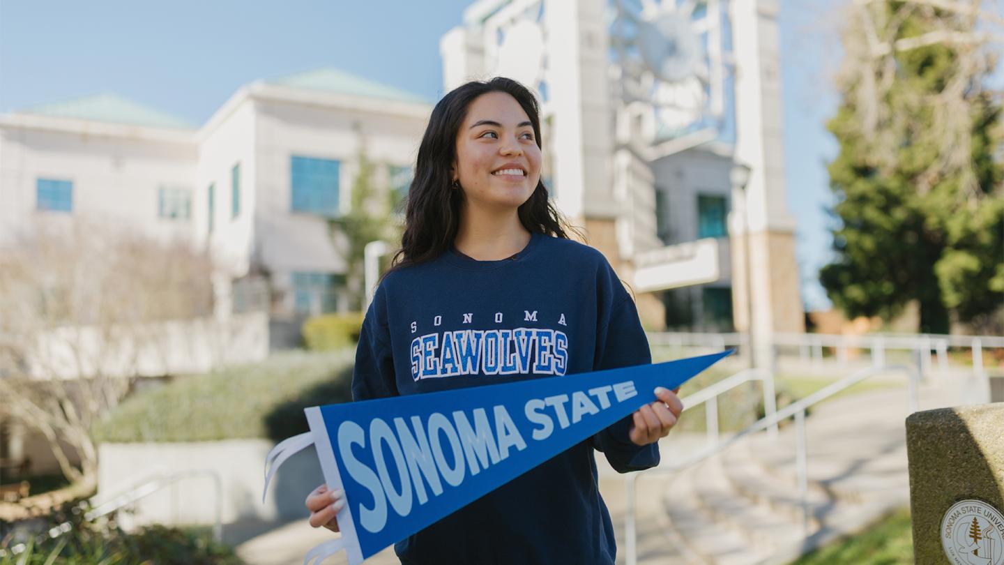 Freshman student holding an SSU flag