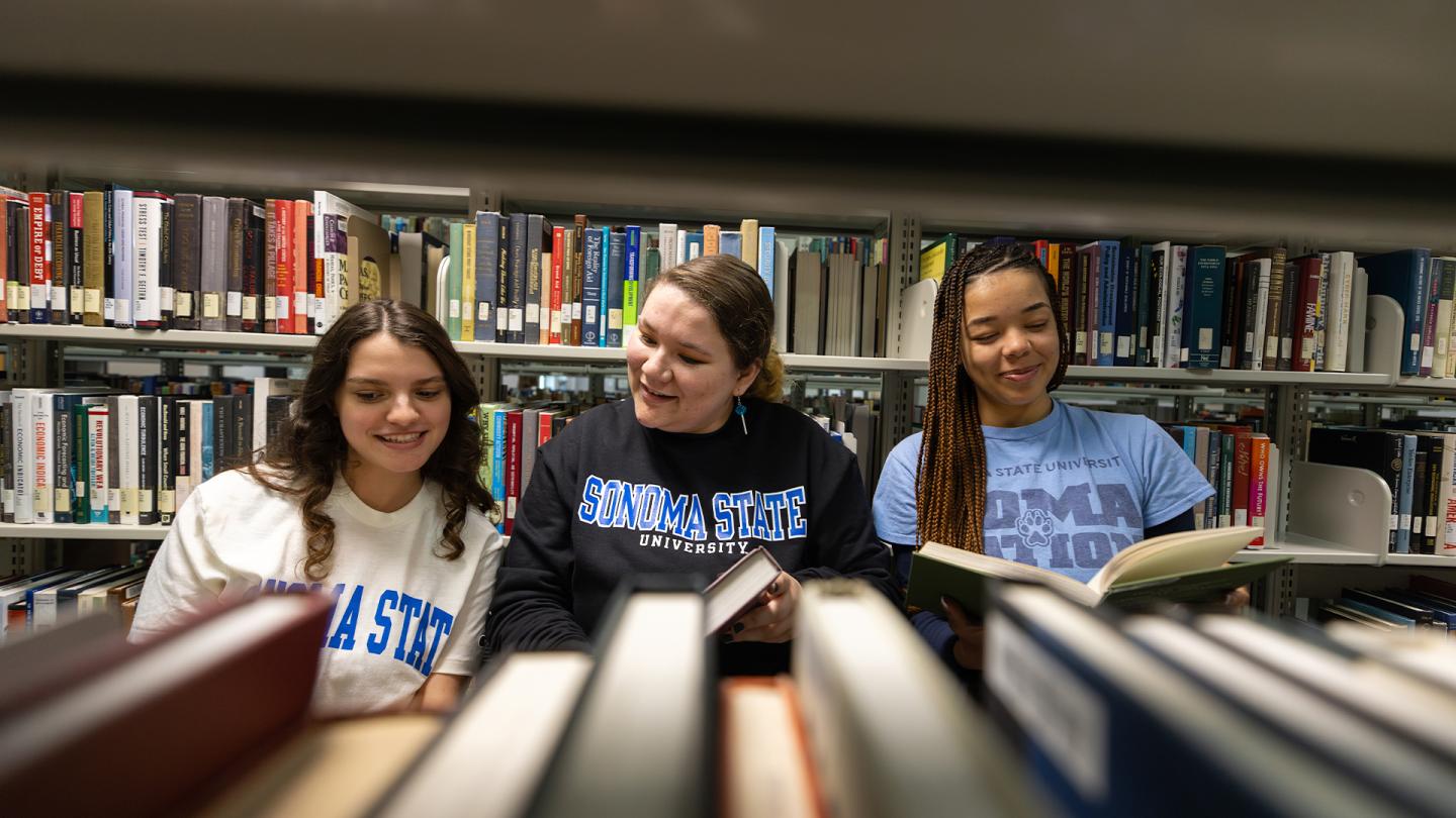 Students reading books at the library