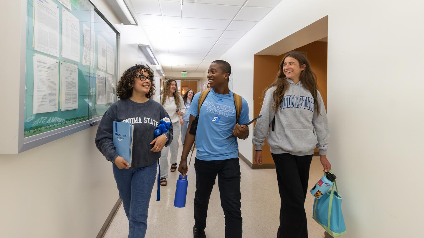 3 students walking to class at darwin hall