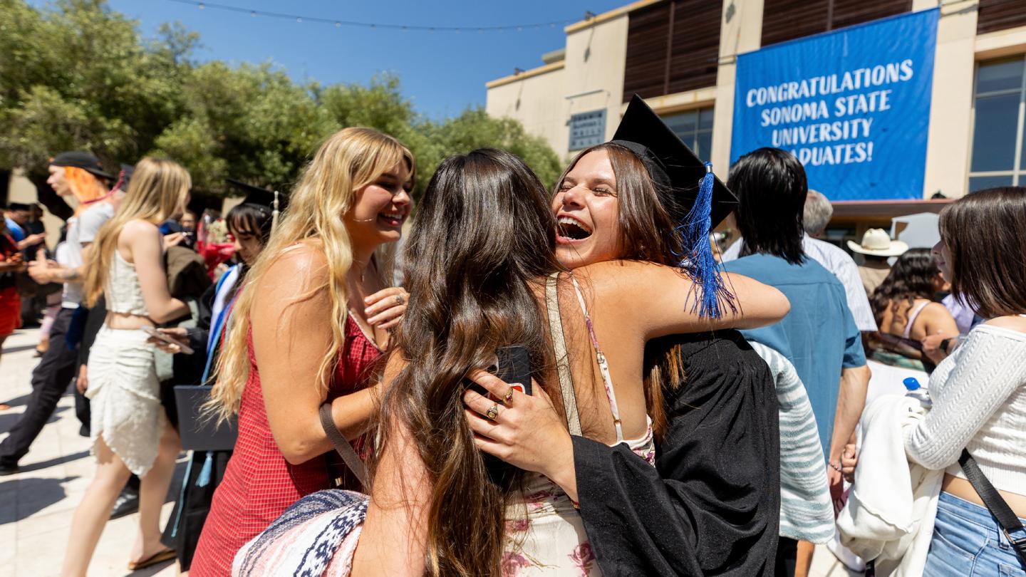 graduate huging family outside gmc