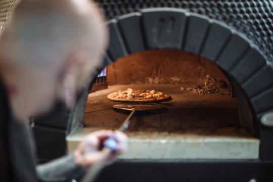 pizza coming out of the oven