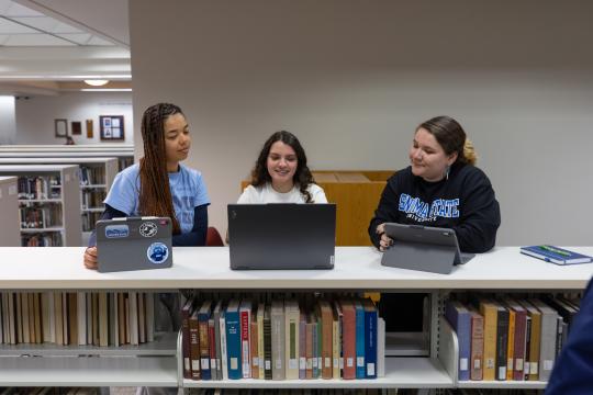 3 students looking at their transcripts