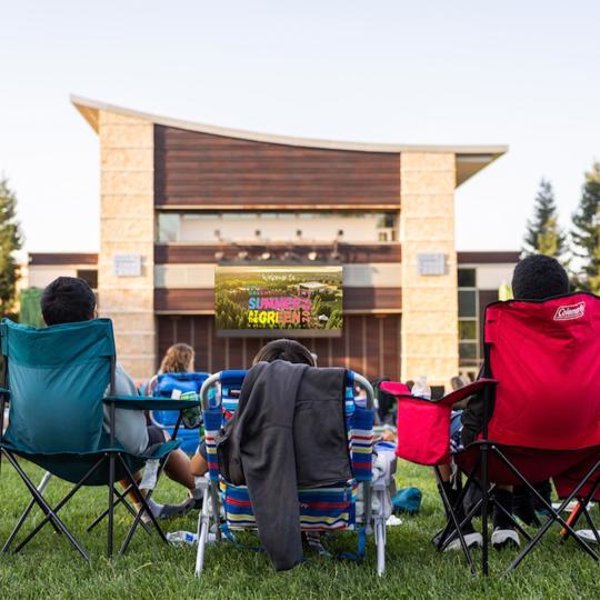 students watching a movie at the green