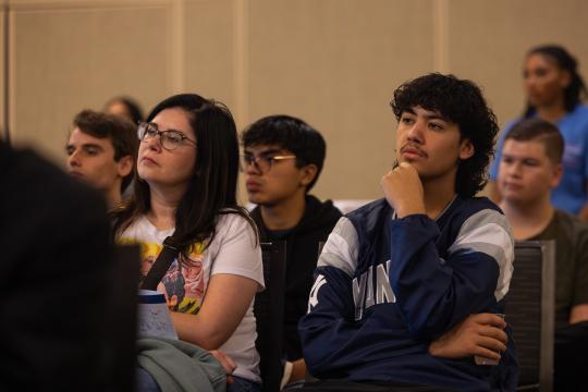 Student and parent sitting listening to a presentation