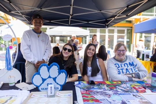 Group of people sitting at a table with brochures in front of them