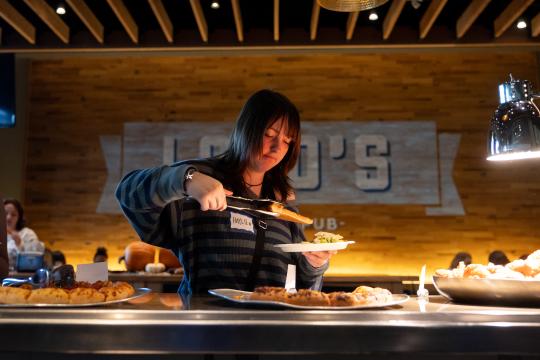 Person grabbing pizza