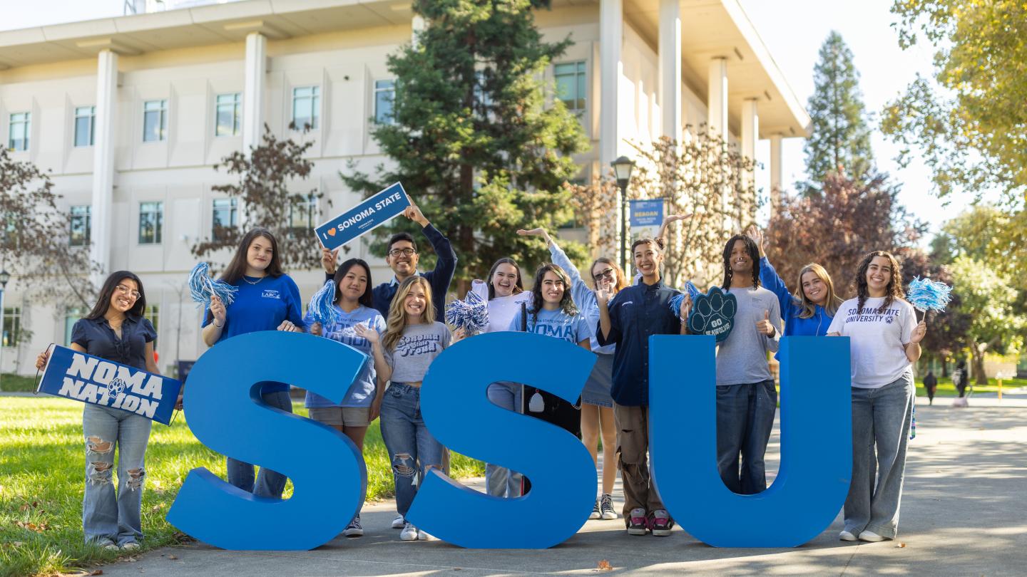 Group of students standing infront of SSU sign cheering